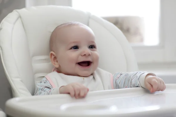 Happy baby in highchair — Stock Photo, Image