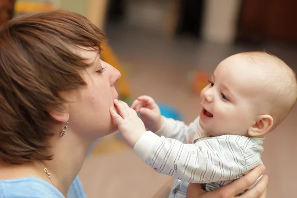 Baby touching his mother — Stock Photo, Image