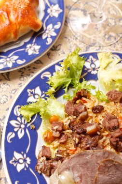 Uzbek national dish - plov with horse meat clipart