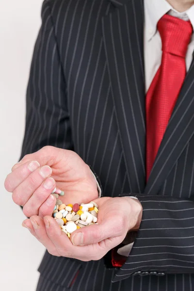 Man holding pills — Stock Photo, Image