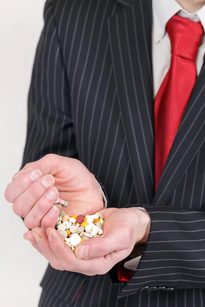 stock image Man holding pills