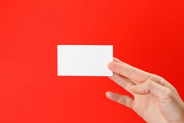 Business 's hand holding blank white paper business card — стоковое фото