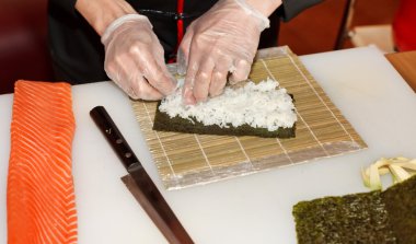 Chef preparing sushi in the kitchen clipart