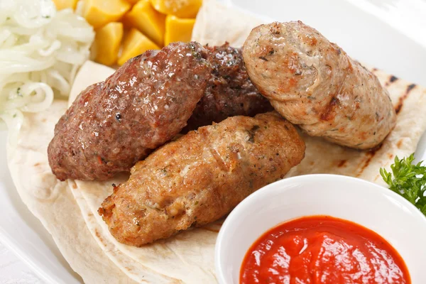 Tasty cutlets with sauce and tortilla — Stock Photo, Image