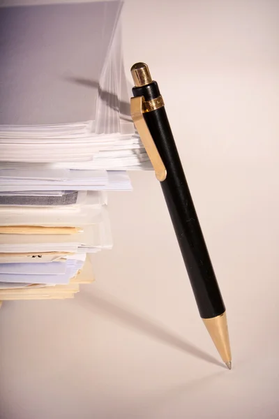 En penna nära papperstapel — Stockfoto