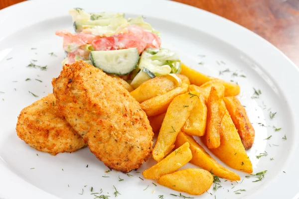 Chicken cutlet with fried potatoes — Stock Photo, Image