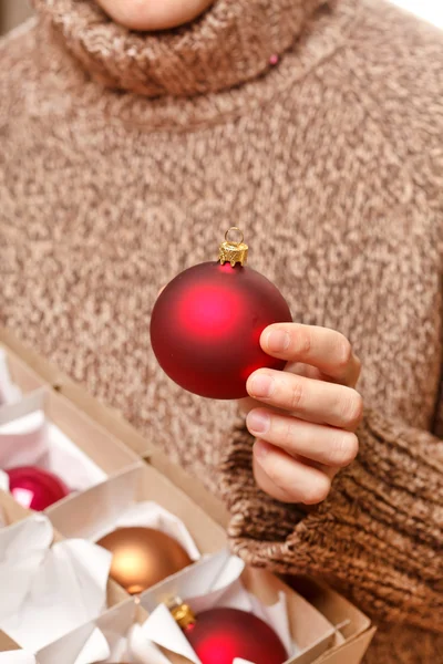 Christmas ball in the hands — Stock Photo, Image