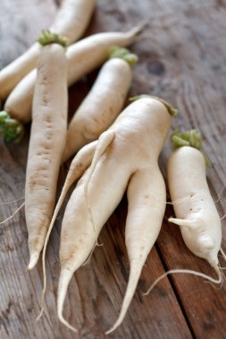 Daikon radish on the wood background clipart