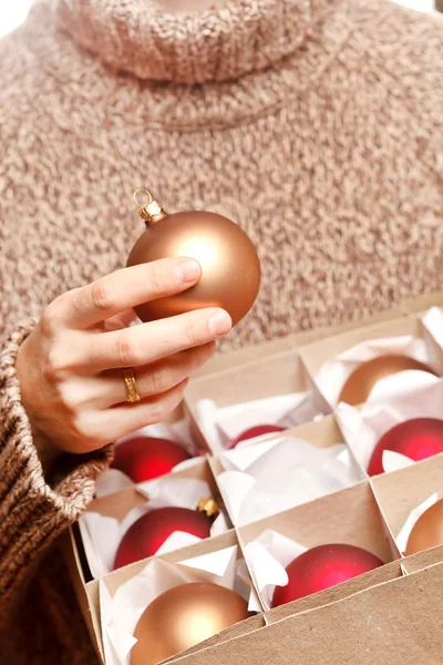 Christmas ball in the hands — Stock Photo, Image