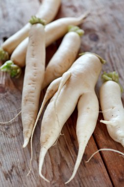 Daikon radish on the wood background clipart