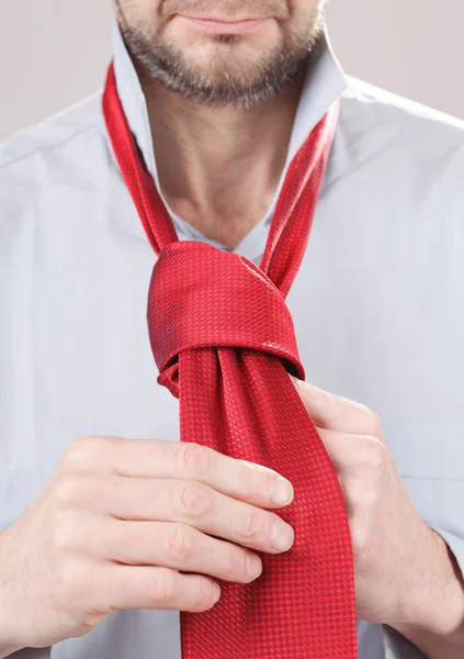 Man adjusting tie — Stock Photo, Image