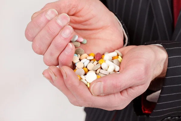 stock image Man holding pills