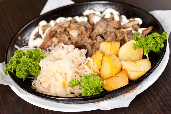 Meat with potatoes in the pot — Stock Photo, Image