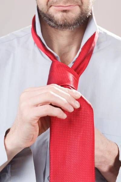 Man adjusting tie — Stock Photo, Image