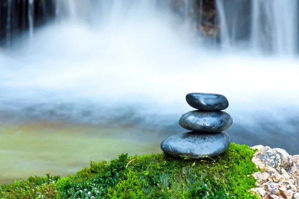 Pebble stones over waterfall Royalty Free Stock Images