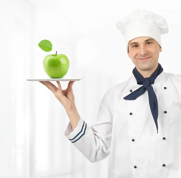 Koch Mann mit grünem Apfel — Stockfoto