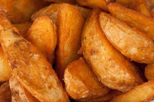 Bratkartoffeln. Fast Food Hintergrund — Stockfoto