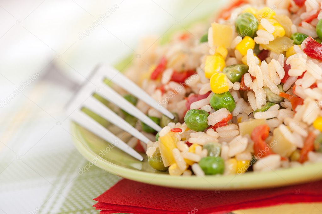 Bowl of rice with peas and red peppers