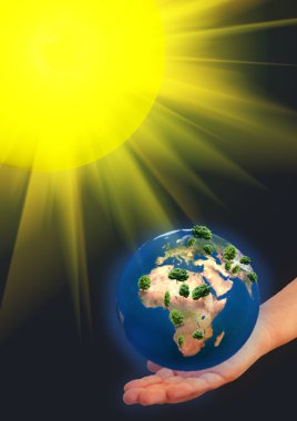 Earth model on a hand clipart