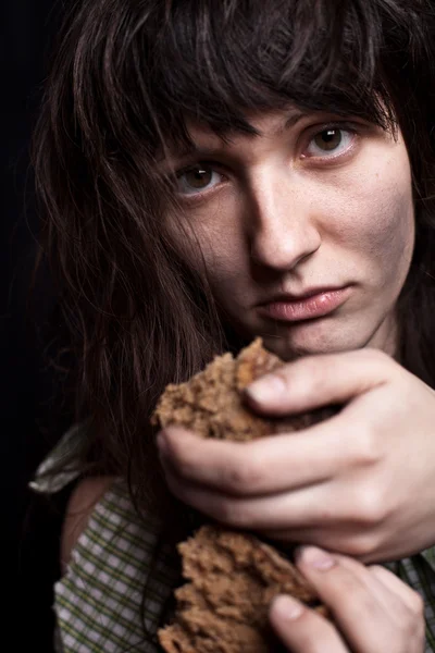 Beggar woman with a piece of bread — Stock Photo, Image