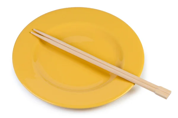 stock image Yellow plate with chopsticks