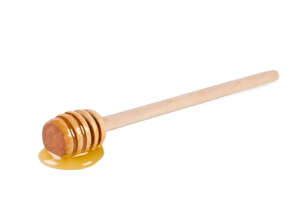Bâton en bois avec du miel sur fond blanc . — Photo