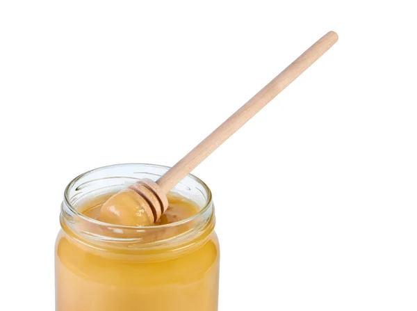 Jar honey and wooden spoon. Royalty Free Stock Images