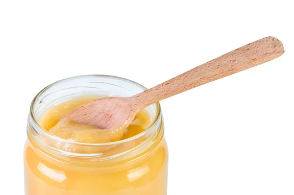 Honey in jar with wooden spoon. — Stock Photo, Image