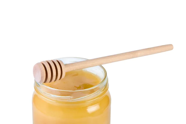 Jar with honey and wooden stick. — Stock Photo, Image