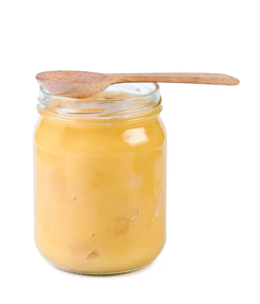 Glass jar with honey and wooden spoon. — Stock Photo, Image