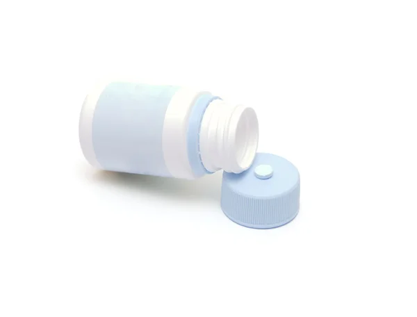 Vial from tablets and a tablet on a cover — Stock Photo, Image