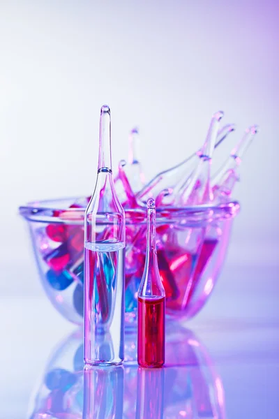 stock image Medical ampoules still life in vivid violet colors