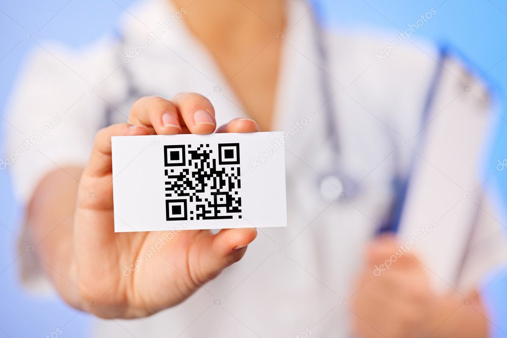 Doctor holding business card with health care QR code on blue