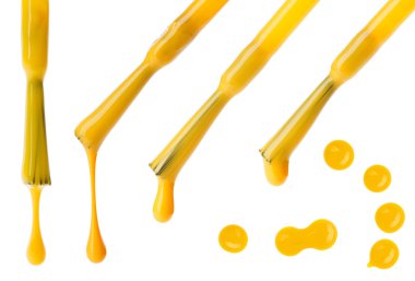 Set of yellow nail polish brushes and drops isolated on white clipart