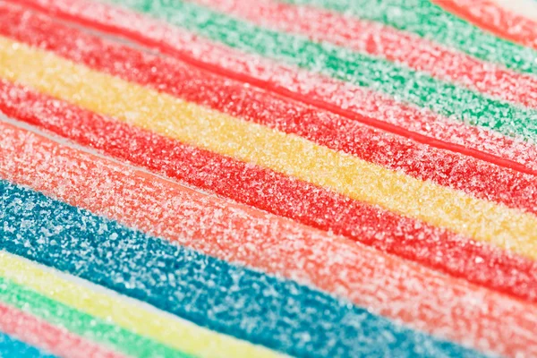 Dulces gomosos multicolores (regaliz) primer plano fondo de los alimentos — Foto de Stock