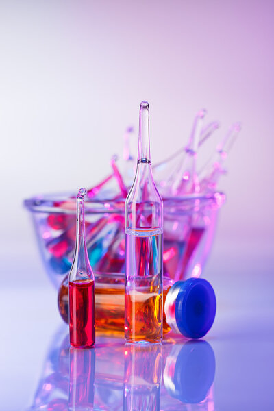 Medical ampoules still life in vivid violet colors