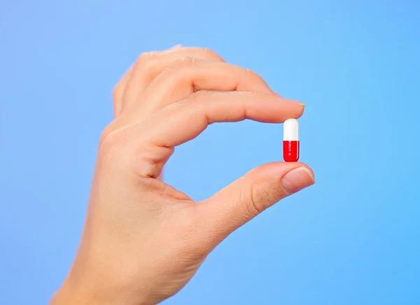 Rode en witte bolus (capsule) in arts hand, macro weergave — Stockfoto