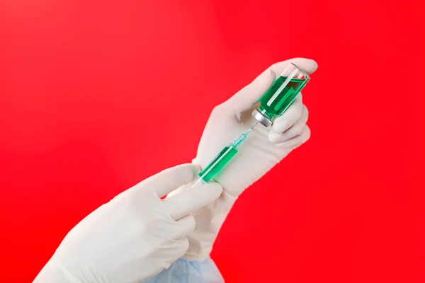 Preparing injection, hands in sterile gloves with ampoule and sy — Stock Photo, Image