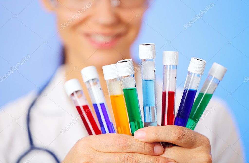 Medical multicolor test tubes with fluid sample in doctor hands