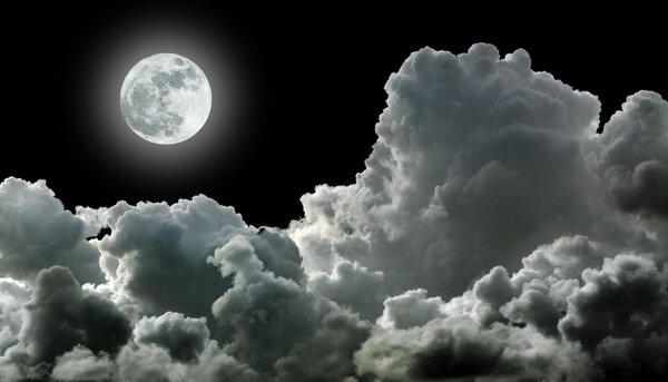 Moon in black stormy clouds