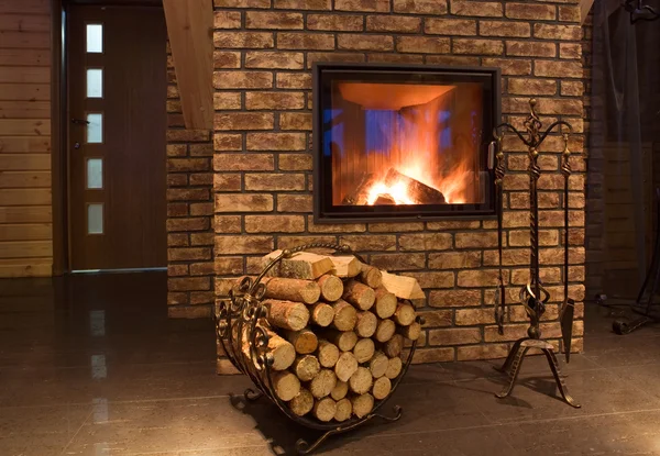 Fire wood against a fireplace — Stock Photo, Image