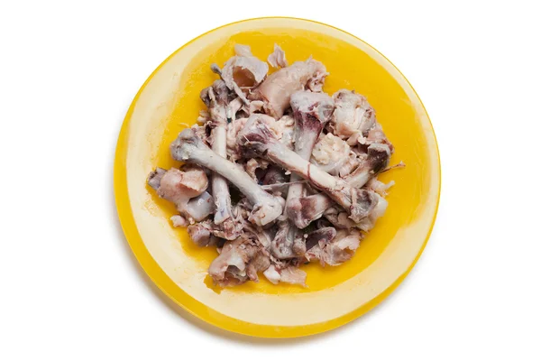 Chicken bones on plate — Stock Photo, Image
