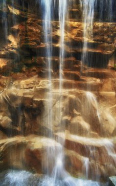 Waterfall over rocks clipart