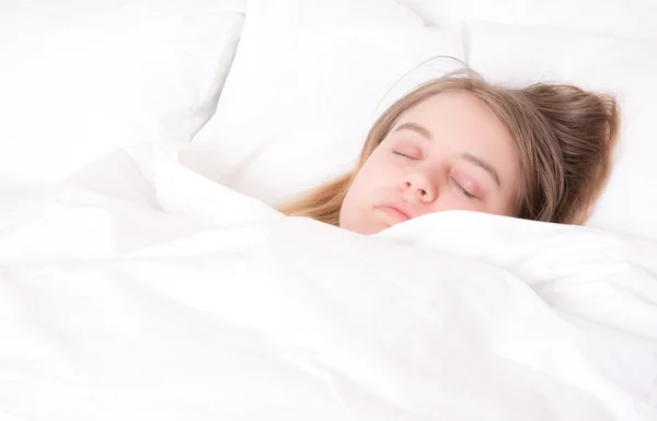 Young woman asleep in bed — Stock Photo, Image