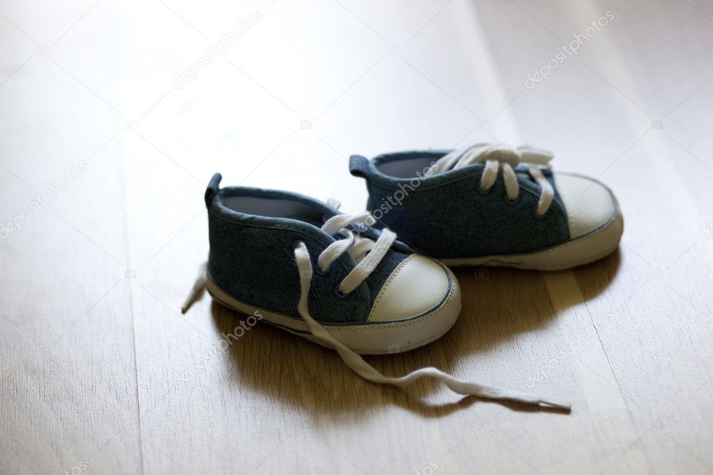 A pair of blue shoes on wooden surface