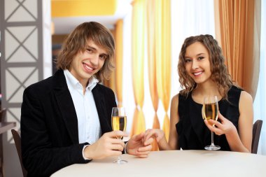 Couple in a restaurant with shampagne clipart