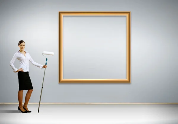 Young businesswoman with a paint brush — Stock Photo, Image