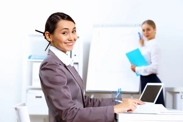 Young woman in business wear working in office — Stock Photo, Image