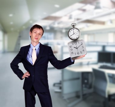 Businessman in office holding clock pyramid clipart