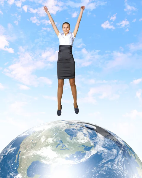 Young woman jumping and our planet earth — Stock Photo, Image